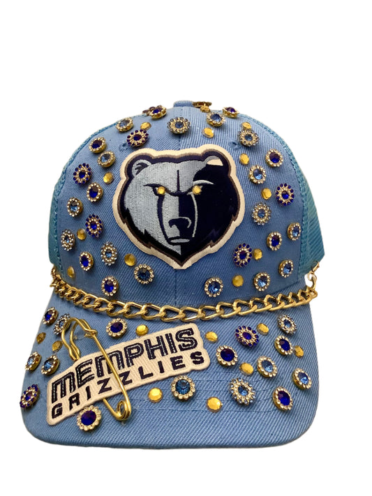 Decorative Memphis Grizzlies cap with embellishments on a neutral background